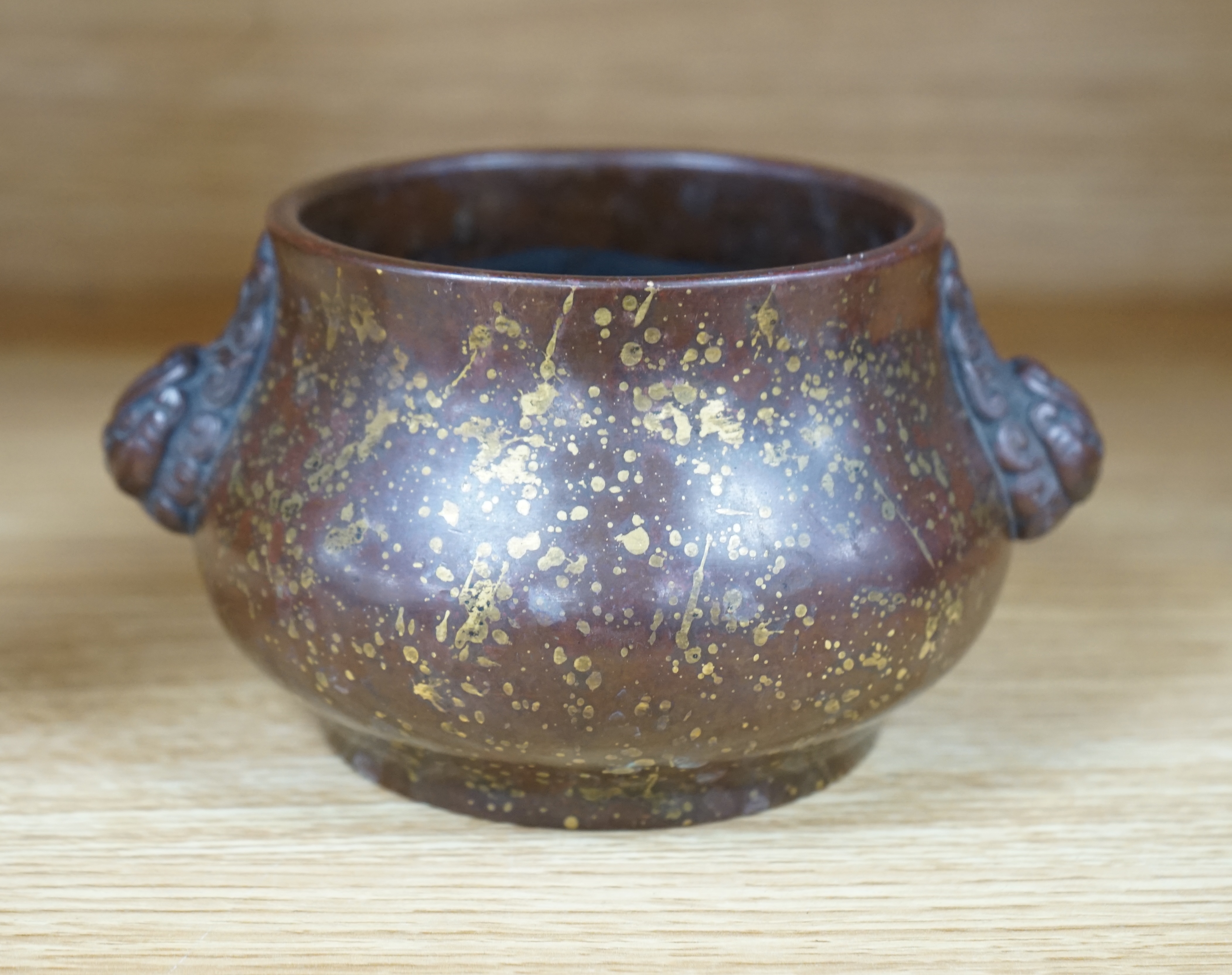 A Chinese gold splashed bronze censer, gui, four character mark, 9cm high. Condition - good